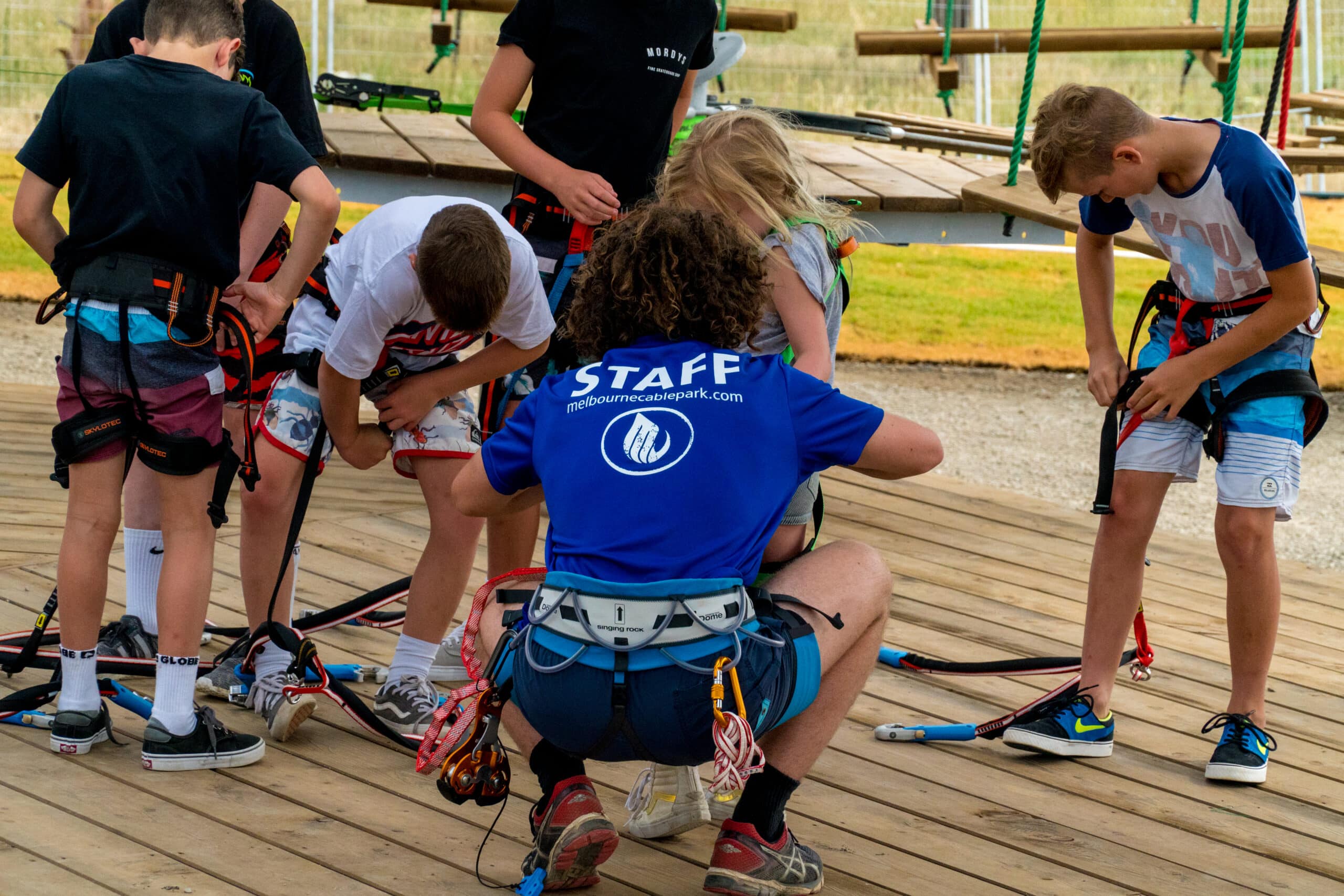staff preparing kids for high ropes
